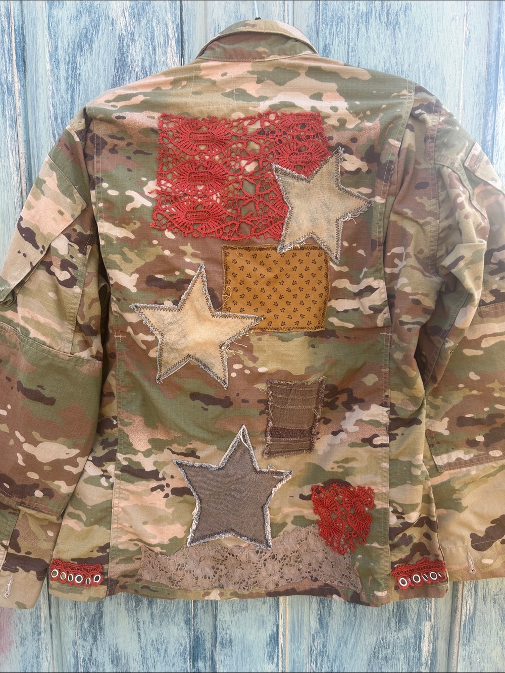 Upcycled crochet lace star and butterfly patched camouflage army utility jacket